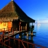 Photo suivante : Bungalow sur l'eau au coucher de soleil � Rangiroa.