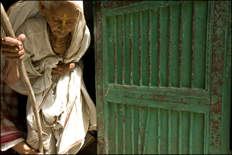 A widow emerging from an Ashram in Vrindavan