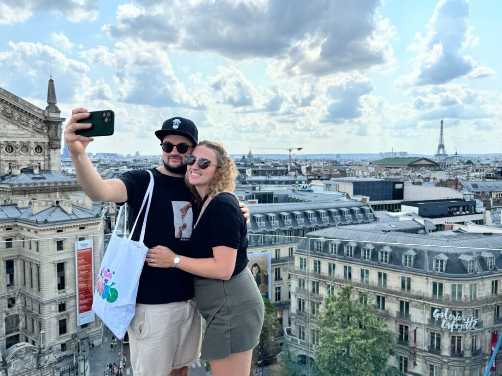 Couple sur le toit-terrasse des Galeries Lafayette avec vue sur la Tour Eiffel
