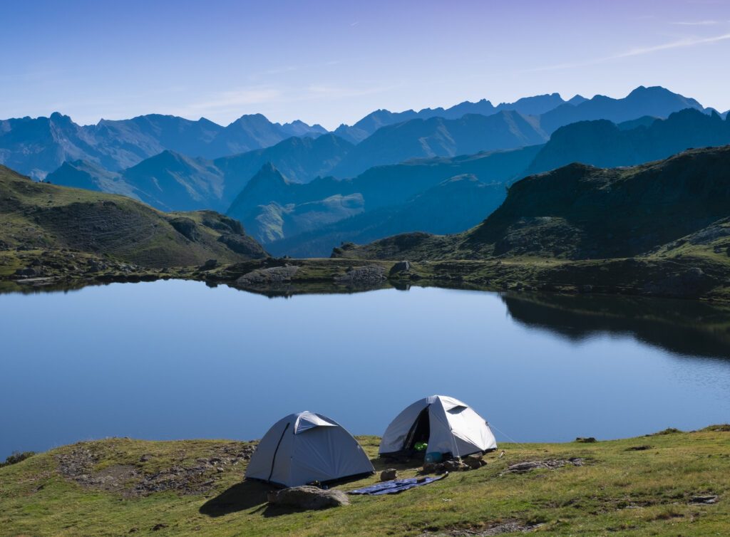 camping tent with the midi d'Ossau and the sun in the background in the Pyrenees National Park, France