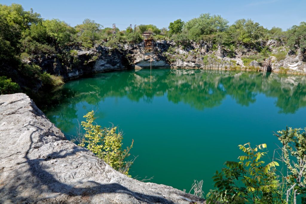 Scenic view of lake Otjikoto - a permanent sinkhole lake near Tsumeb in Northern Namibia .