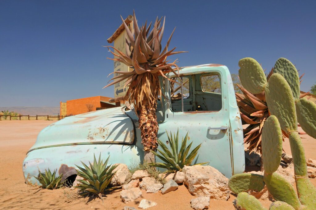 Old and rusty car wreck at the last gas station before the Namib desert. Solitaire, Namibia.