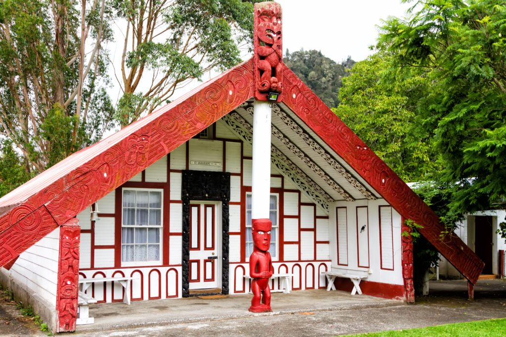 KORINTI, NEW ZEALAND - FEB 23, 2017:  New Zealand carved maori marae (meeting house and meeting ground)
