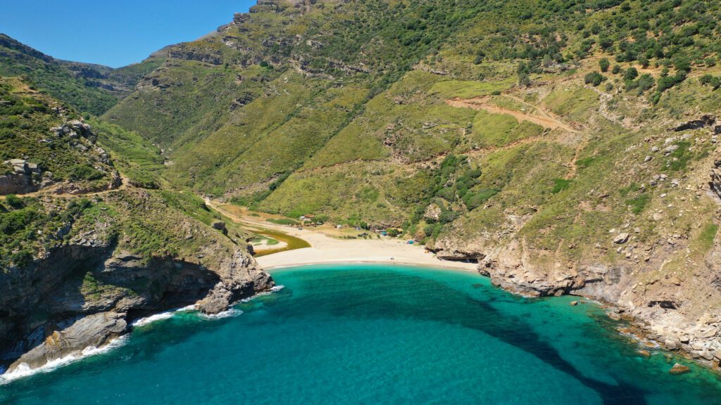 Aerial drone photo of secluded sandy emerald beach and canyon of Agios Dimitrios near Karistos, South Evia island, Greece