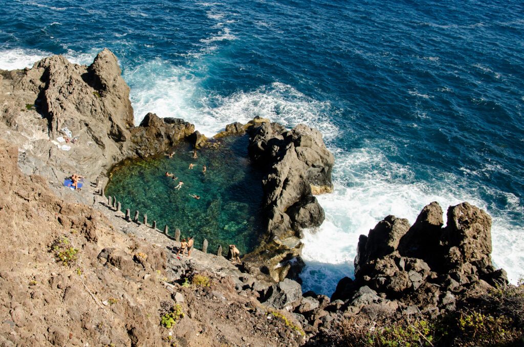 Natural pool next to the ocean created by a volcanic eruption