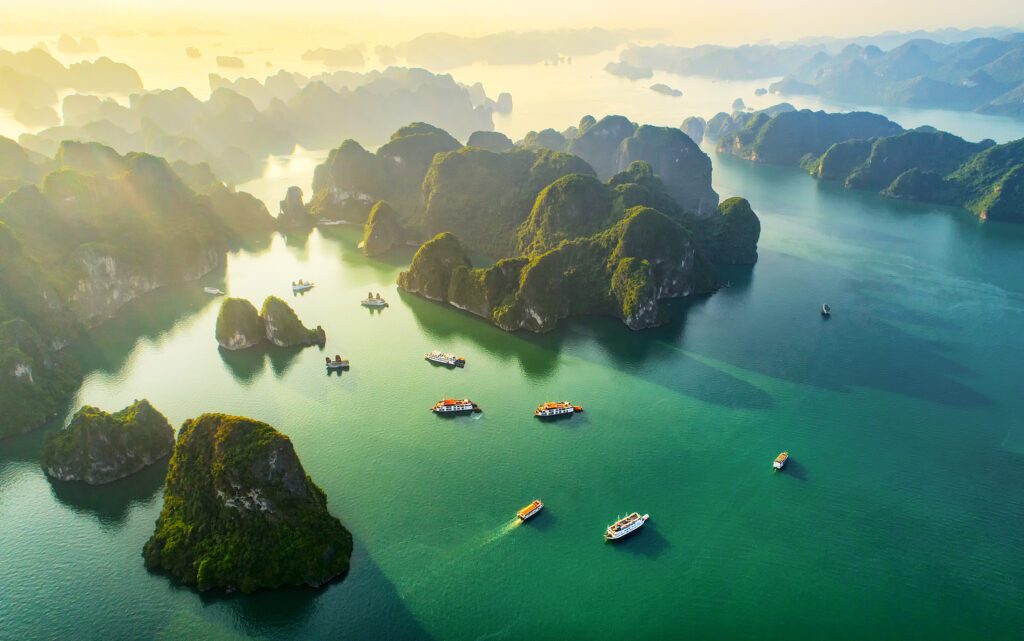 Aerial view floating fishing village and rock island, Halong Bay, Vietnam, Southeast Asia. UNESCO World Heritage Site. Junk boat cruise to Ha Long Bay. Popular landmark, famous destination of Vietnam