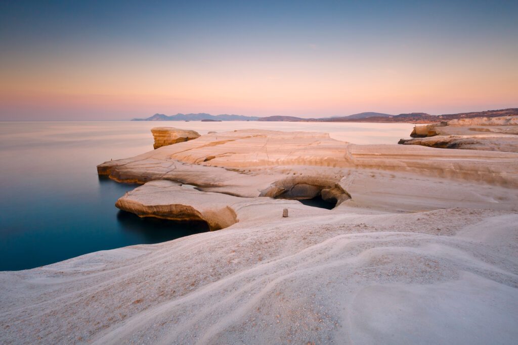 Coastal scenery with pale volcanic rocks near Sarakiniko beach in Milos island, Greece.