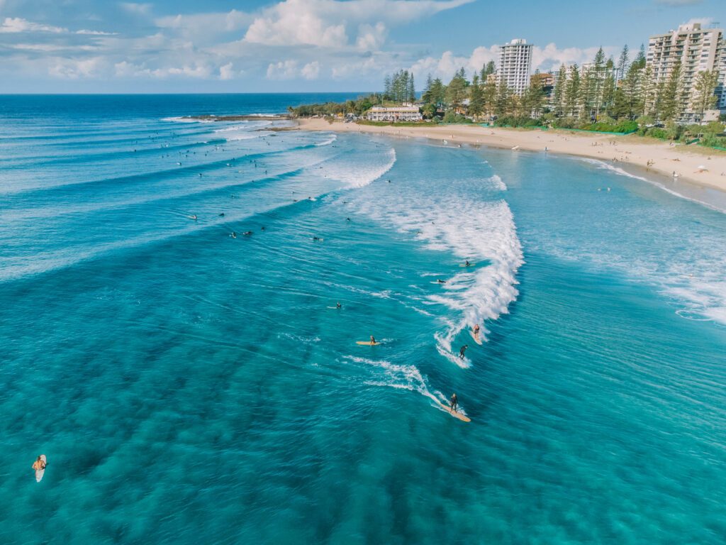 An aerial view of surfers and swimmers at Rainbow Bay, Gold Coast, Australia