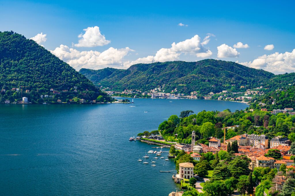 Panorama of Lake Como and the city of Como, the port and the mountains, from Cernobbio, on a summer day.