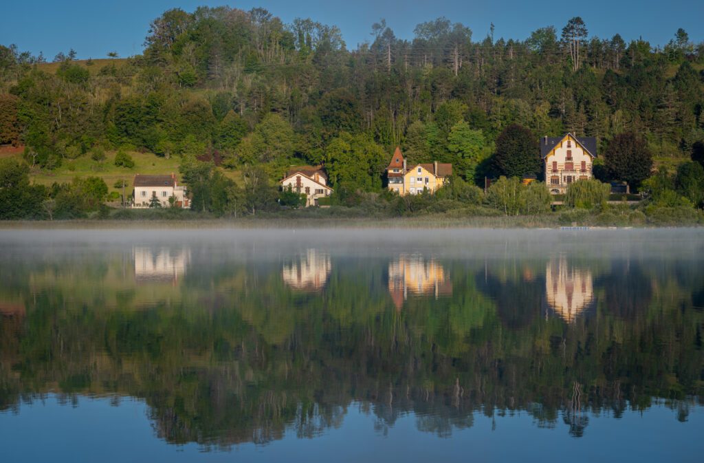 Clairvaux-Les-Lacs, France - 09 02 2020: Fog and reflections on the big lake - La Raillette