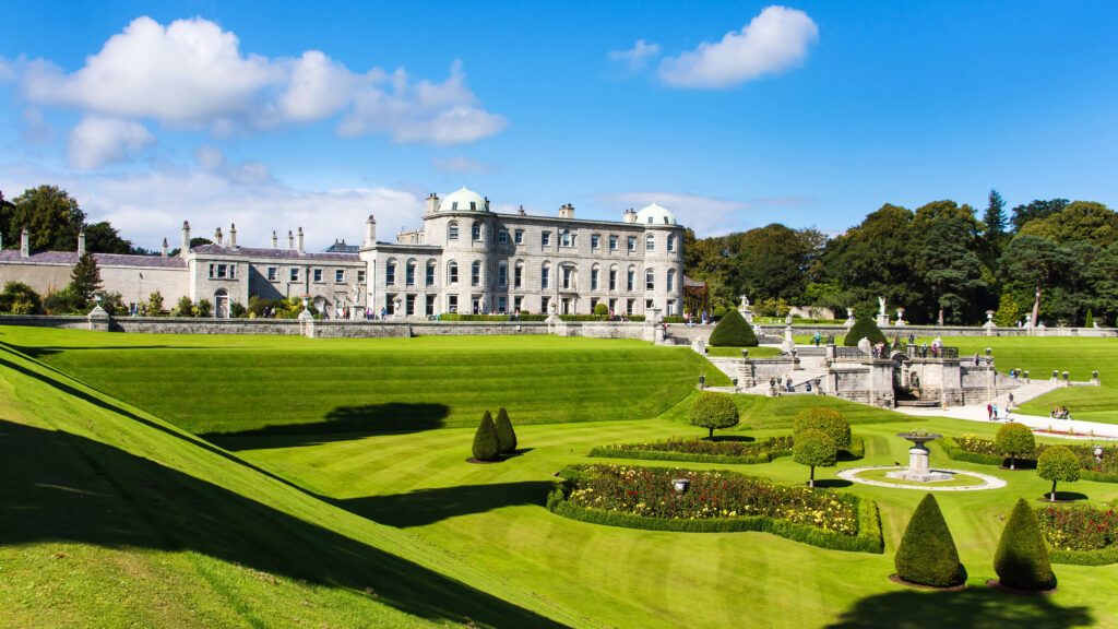 Tourists visiting Powerscourt Gardens one of the most beautiful gardens in Ireland view on mansion from terraced lawn