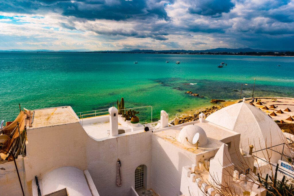 Hammamet, Tunisia. Image of architecture of old medina with dramatic sky at sunset time.