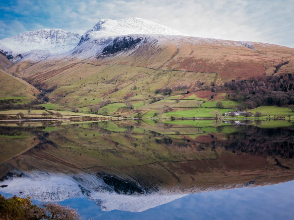 Snow capped Scafell and Scafell Pike, reflected on the quiet Wast Water, in the Lake District