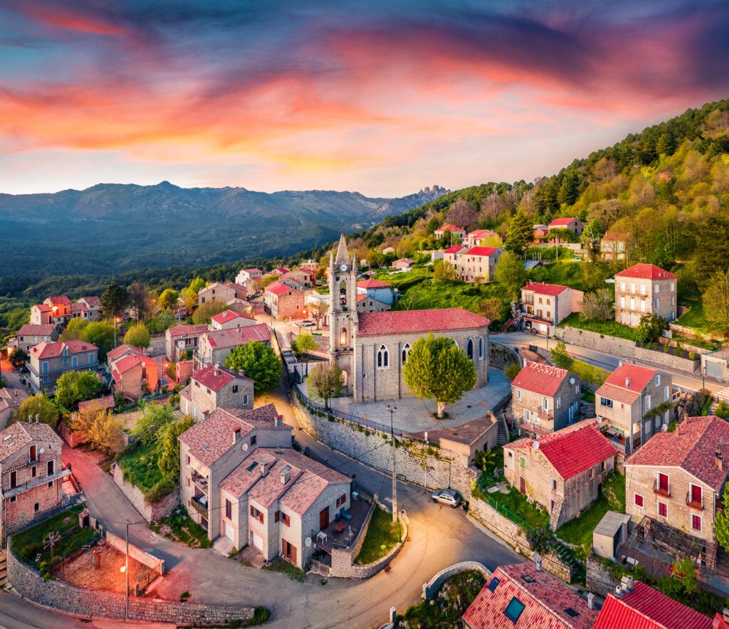 Colorful evening view from flying drone of Zonza town, commune in the Corse-du-Sud department of France. Astonishing sunset on Corsica island, France, Europe. Traveling concept background.