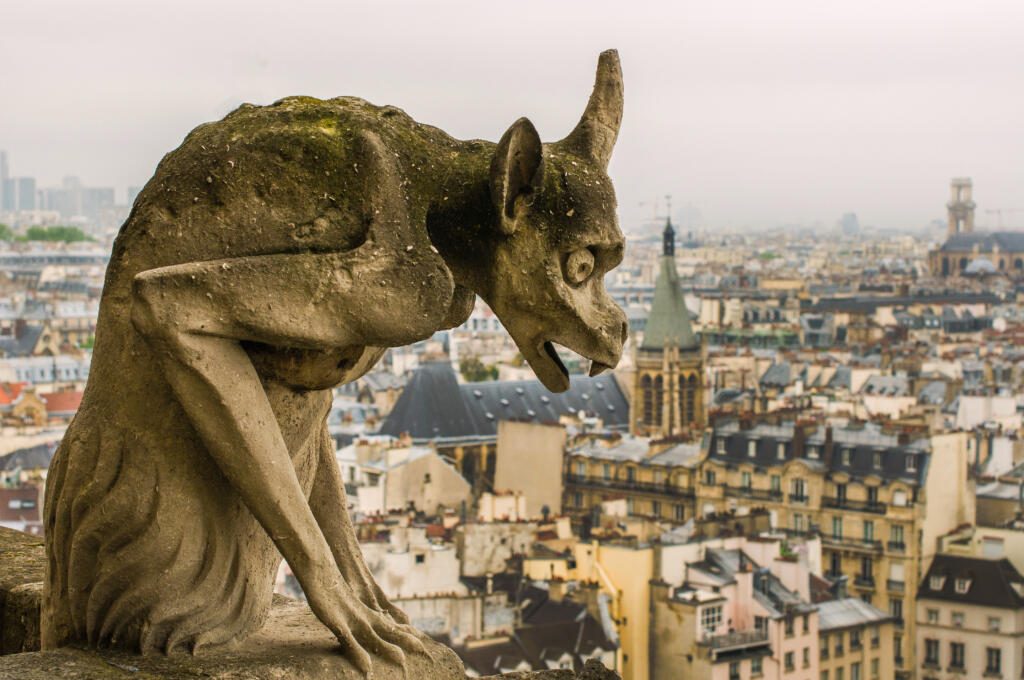 Chimera (gargoyle) of the Cathedral of Notre Dame de Paris overlooking Paris, France