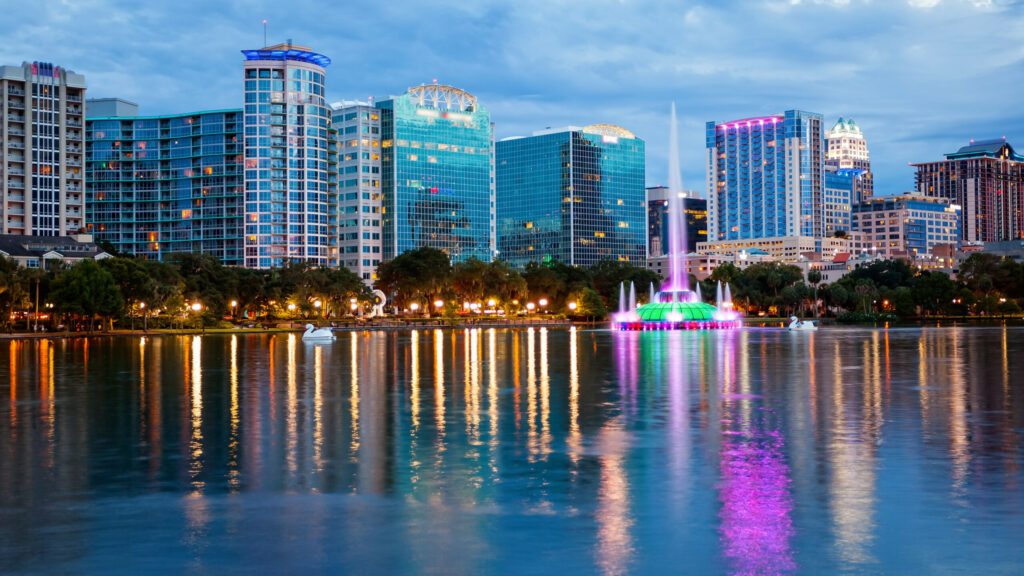 Orlando, Florida City Skyline on Lake Eola as Night Falls (logos blurred for commercial use)