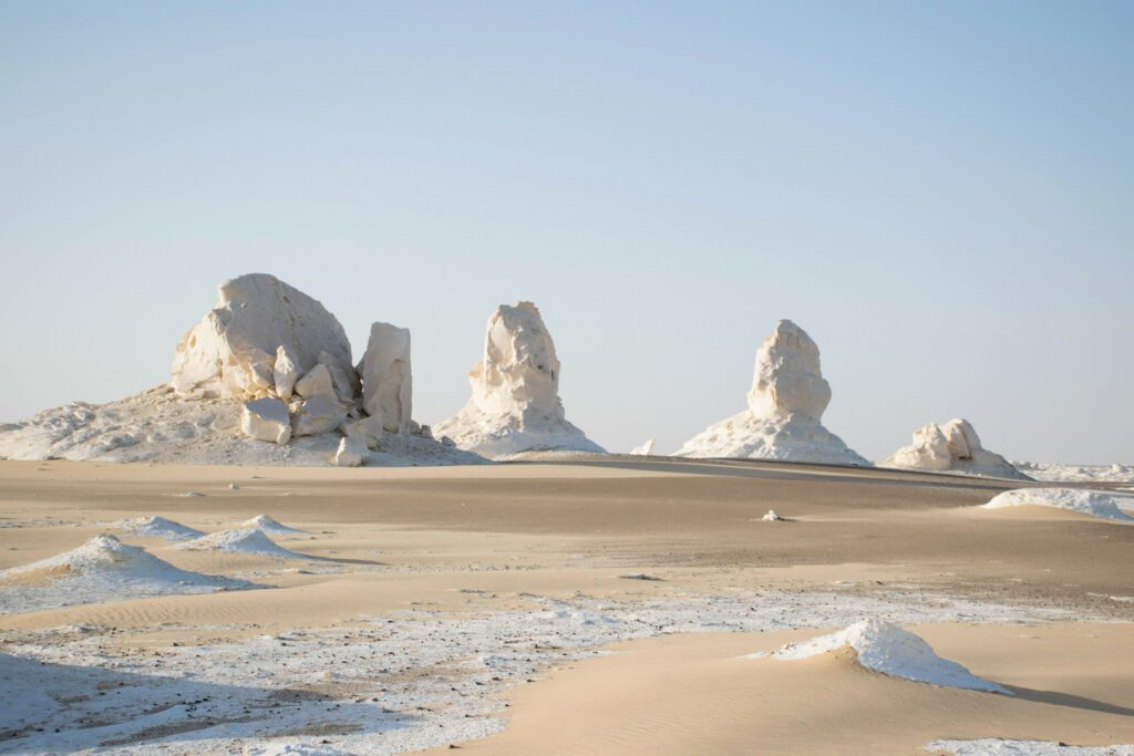 white desert with sand and lime stone rock formations. Bahariya national park Egypt. Surreal nature landscape. Scenic travel destinations africa.