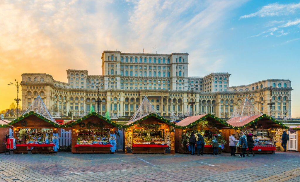 Christmas market and decorations in center of Bucharest, Parliament building in background, Romania