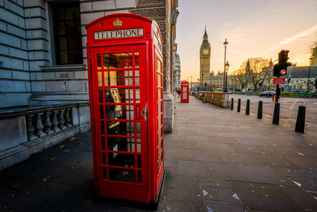 Red telephone box and Big Ben at sunrise in London