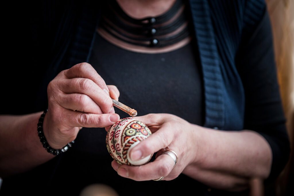 Lady making traditional decorated eggs in the Bukovina Region of Romania