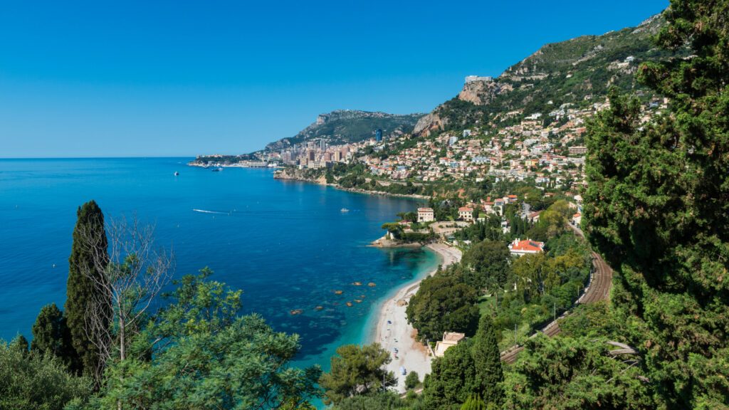 Bay and coastline of Roquebrune-Cap-Martin, Southern France with the city state of Monaco in the distance.