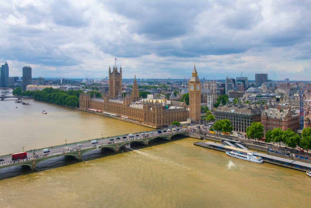 Big Ben, the Palace of Westminster and Westminster Bridge over River Thames aerial view in London, England, UK. The Big Ben and Palace is UNESCO World Heritage Site since 1970.