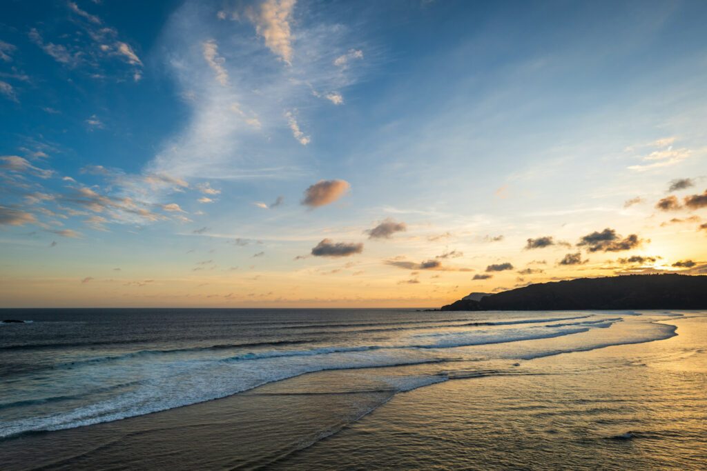 beautiful sunset landscape at tropical beach in Lombok, Indonesia. Bright sunset landscape near Kuta beach area, Lombok, Indonesia