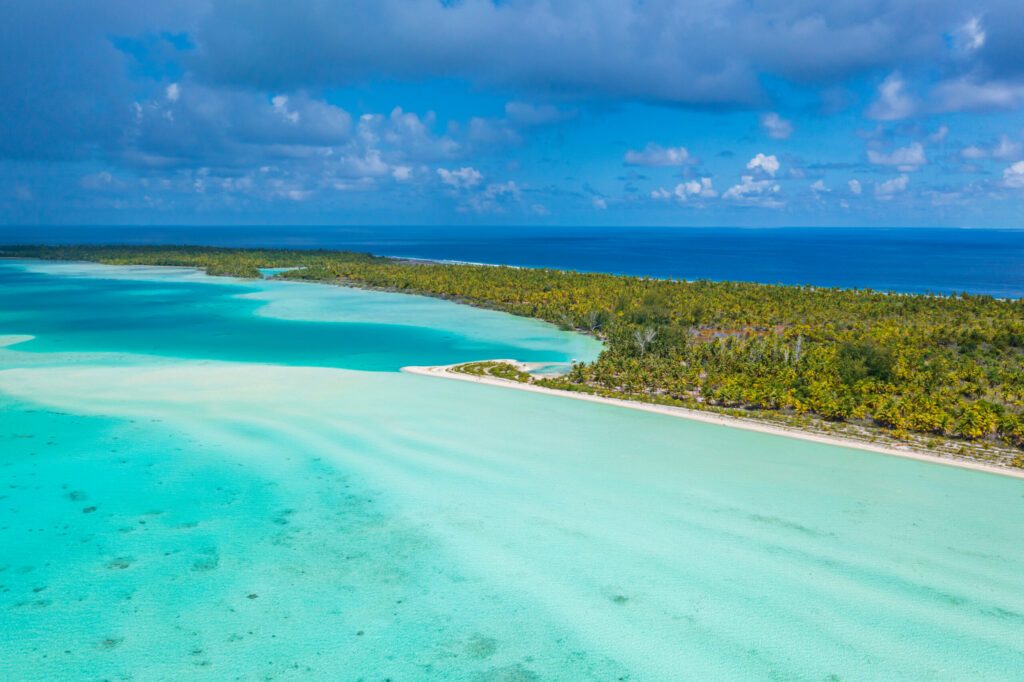 Drone photo of French Polynesia Tahiti Rangiroa Fakarava atoll and Blue Lagoon and motu island with perfect beach and coral reef. Aerial Tropical travel paradise in Tuamotus Islands