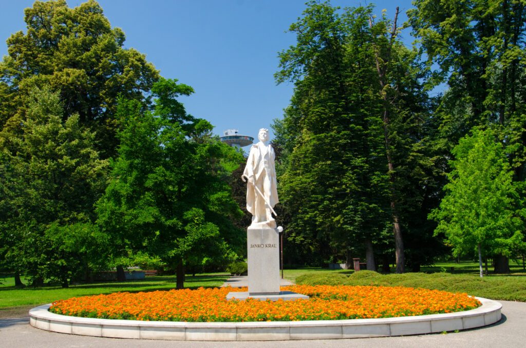 Statue of the famous writer Janko Kral with UFO bridge behind in