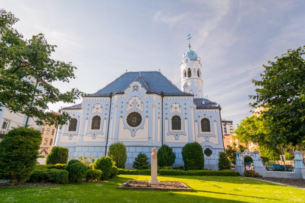 The blue church in Bratislava. Saint Elizabeth church view from the side trough the park.