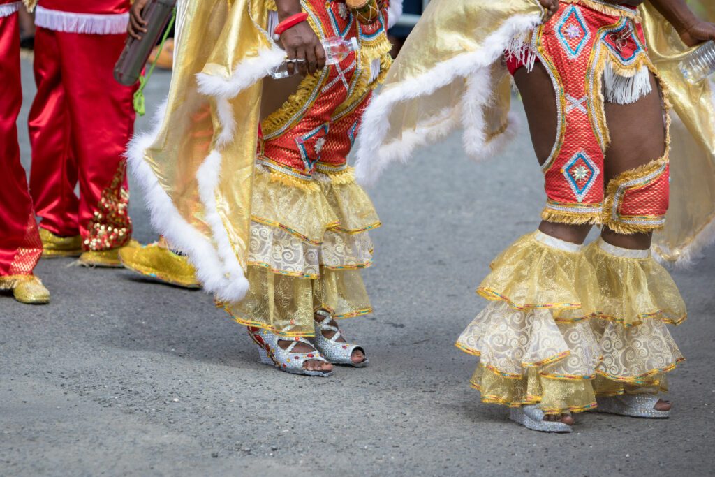 Woman's legs wearing masquerade mask during carnival parade in Guadeloupe, Caribbean