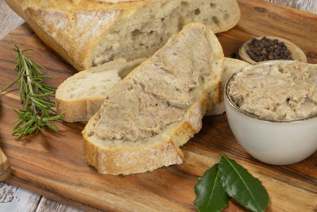 slice of bread with rillette on a wooden board