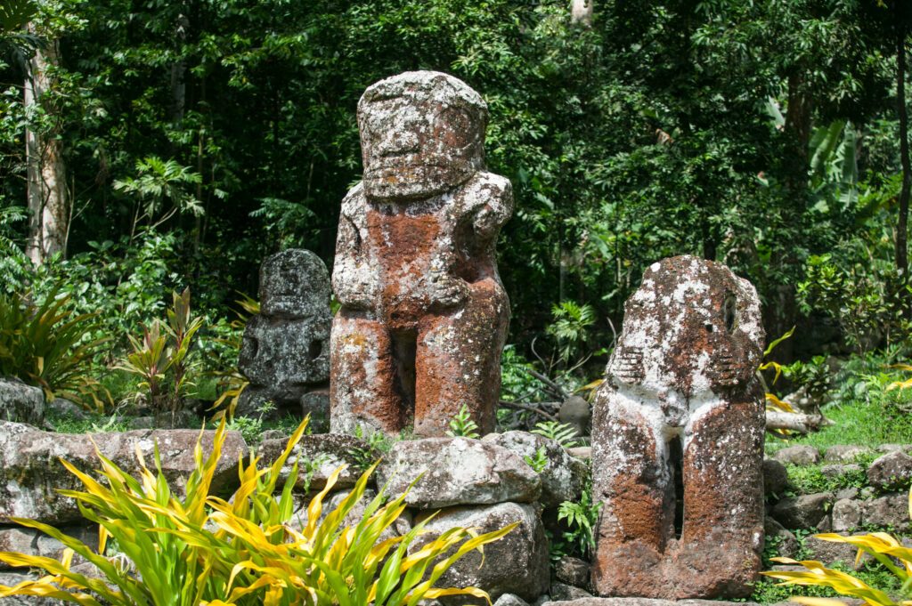 historic stone statues, so called Tikis, created by native inhabitants of Hiva Oa,  Marquesas Islands, French Polynesia