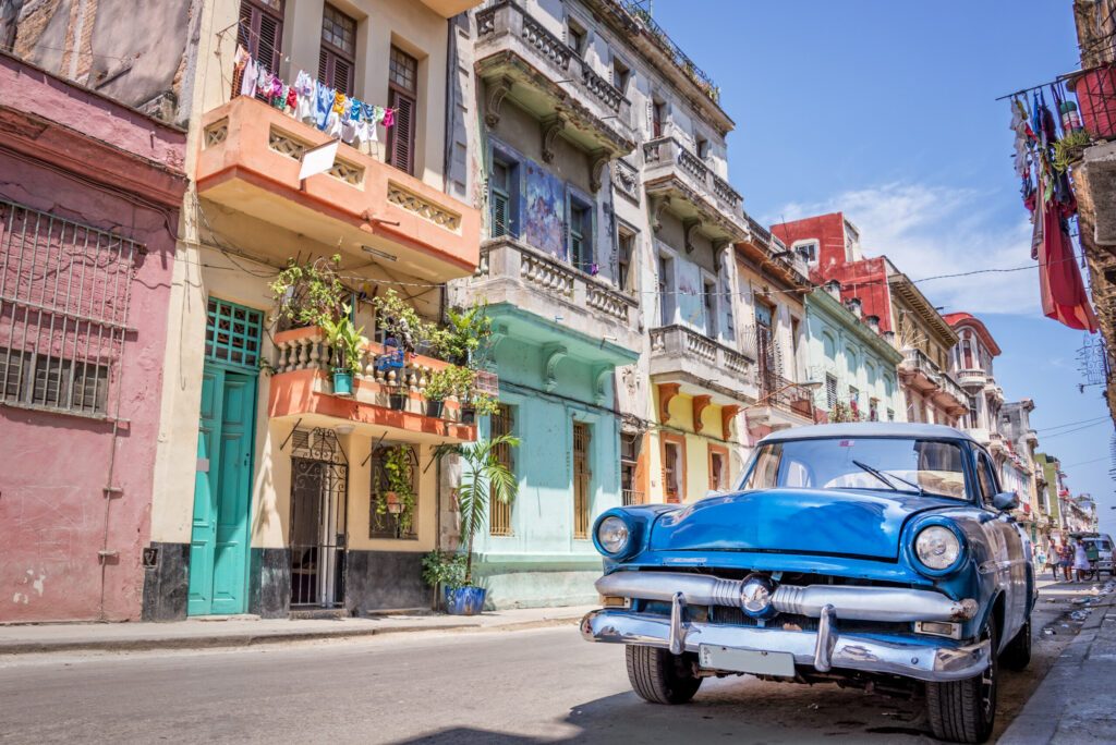 Blue vintage classic american car in a colorful street of Havana, Cuba. Travel and tourism concept.