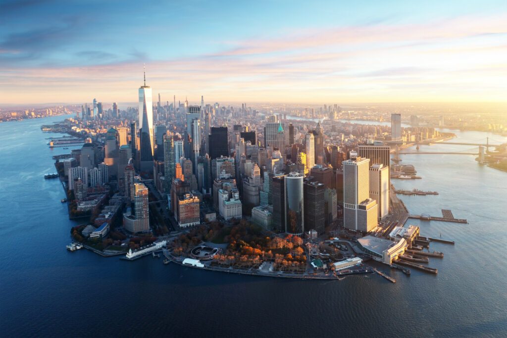 New York City panorama skyline at sunrise. Manhattan office buildings skysrcapers at the morning. New York City panoramatic shot. First sun beams lights up Manhattan of New York City.