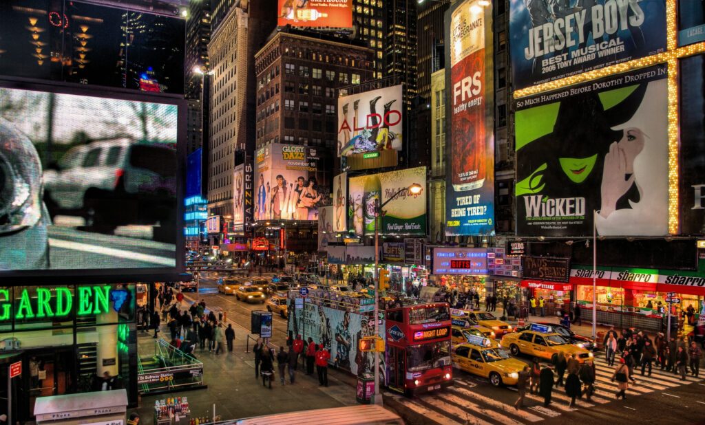 Times Square, New York City looking back toward billboards on Broadway at night