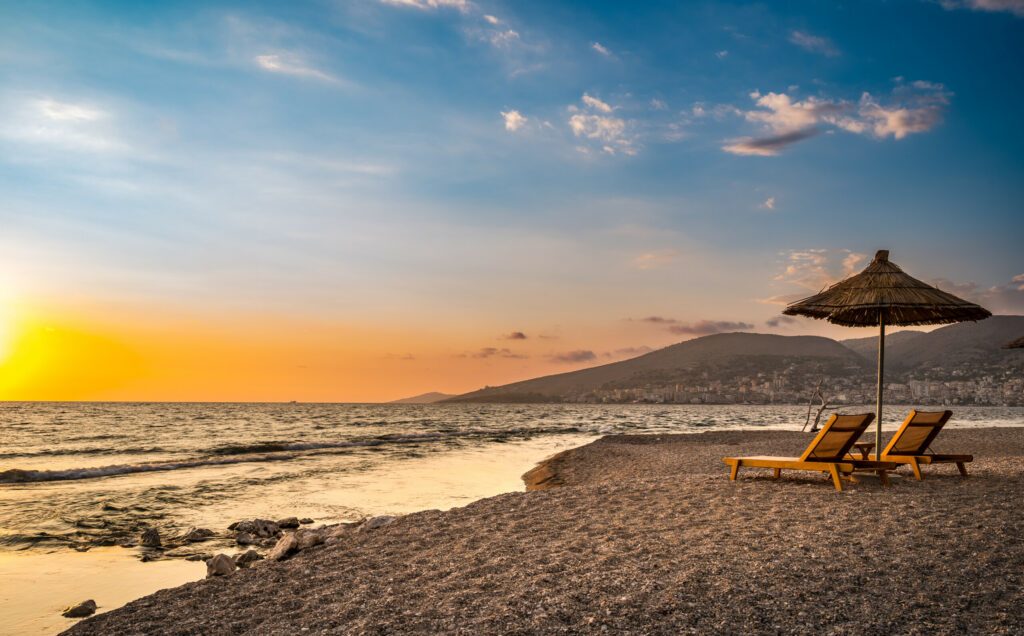 Sarande beach during sunset. Bistrica Beach with view at Sarande city. beautiful evening sky