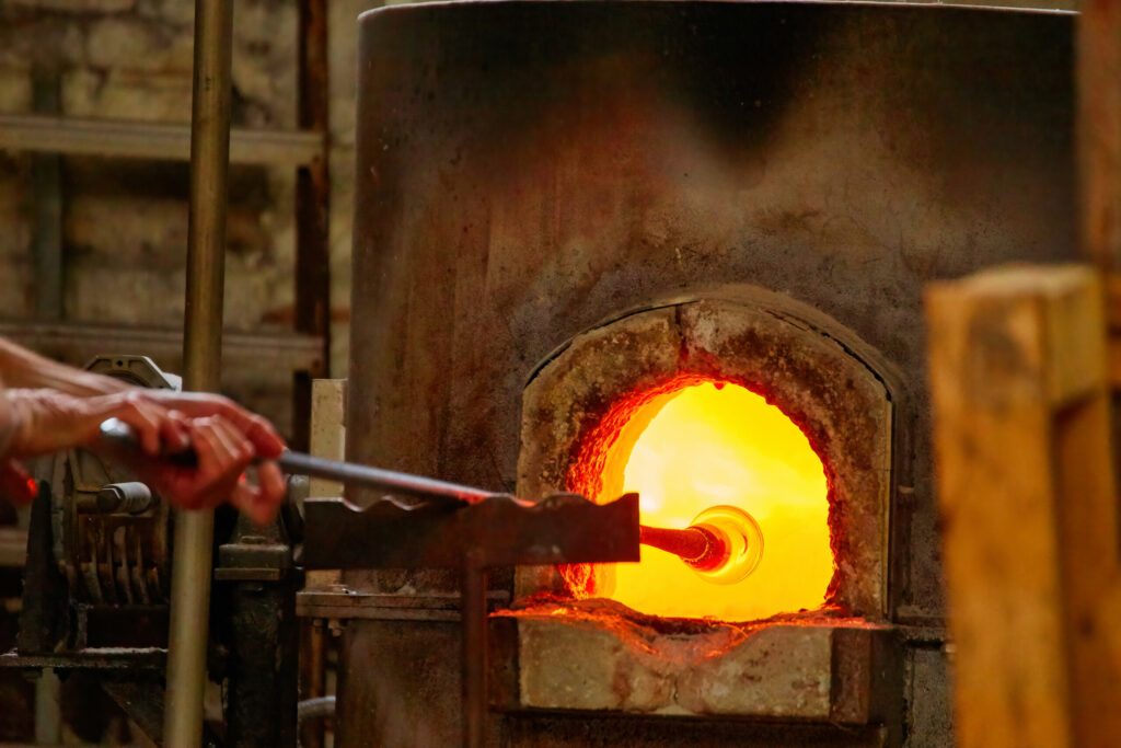 Glass Blower Shaping Molten Glass into a Piece of Art