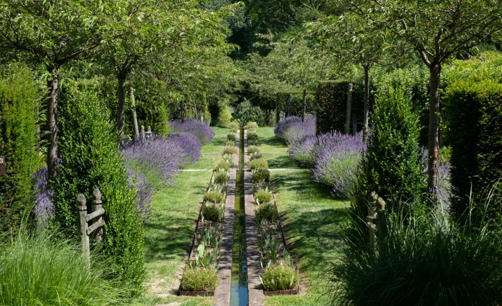 Landscaped garden with lavender and flowing water at Jardin Domaine de Poulaines in the Loire Valley, France. Beautiful garden and arboretum in a secluded spot.