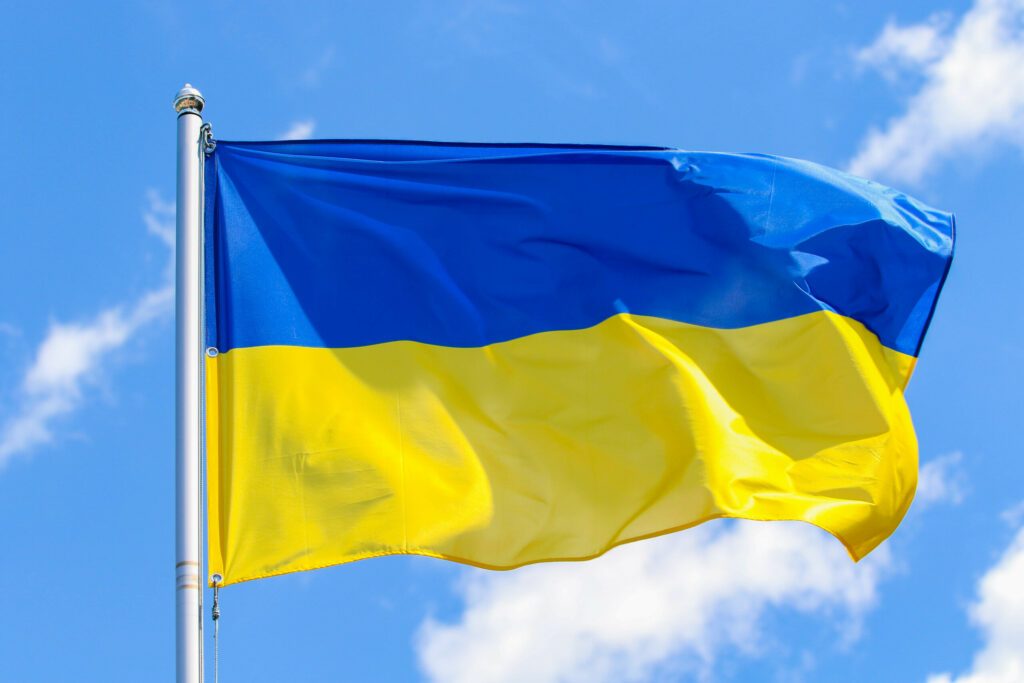 The state flag of Ukraine on a background of blue sky