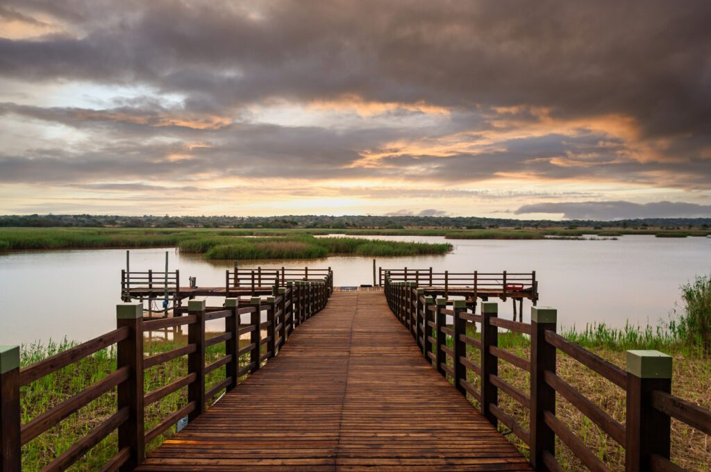 Sunset over a small pier in wetland area of the Isimangaliso National Park in KwaZulu-Natal region of South Africa.