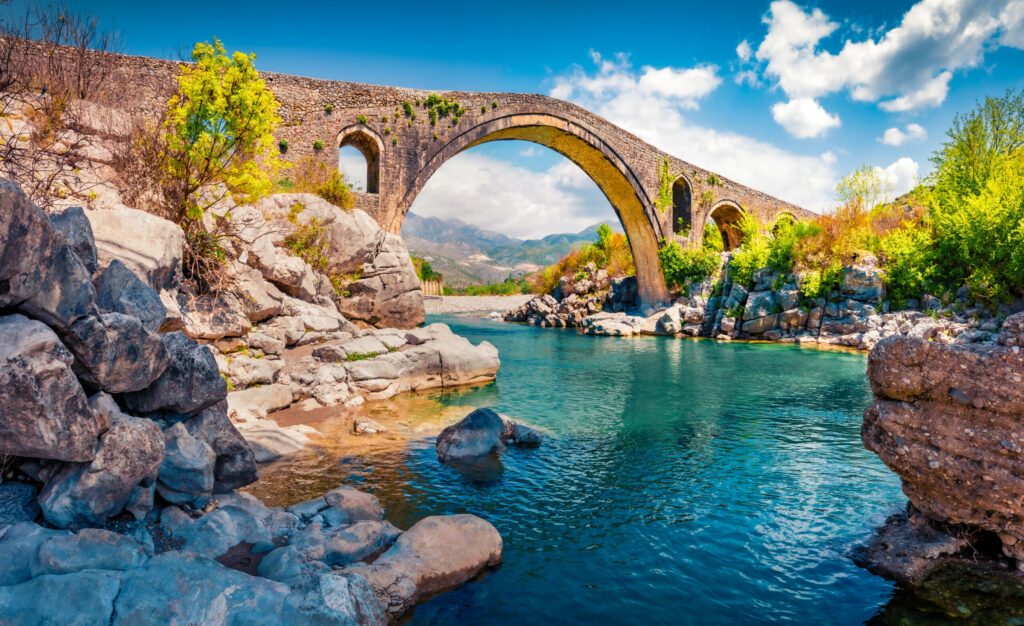 Stunning spring view of Old Mes Bridge. Gorgeous morning landscape of Shkoder. Colorful outdoor scene of Albania, Europe. Traveling concept background.