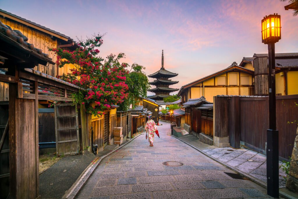 Japanese girl in Yukata with red umbrella in old town  Kyoto