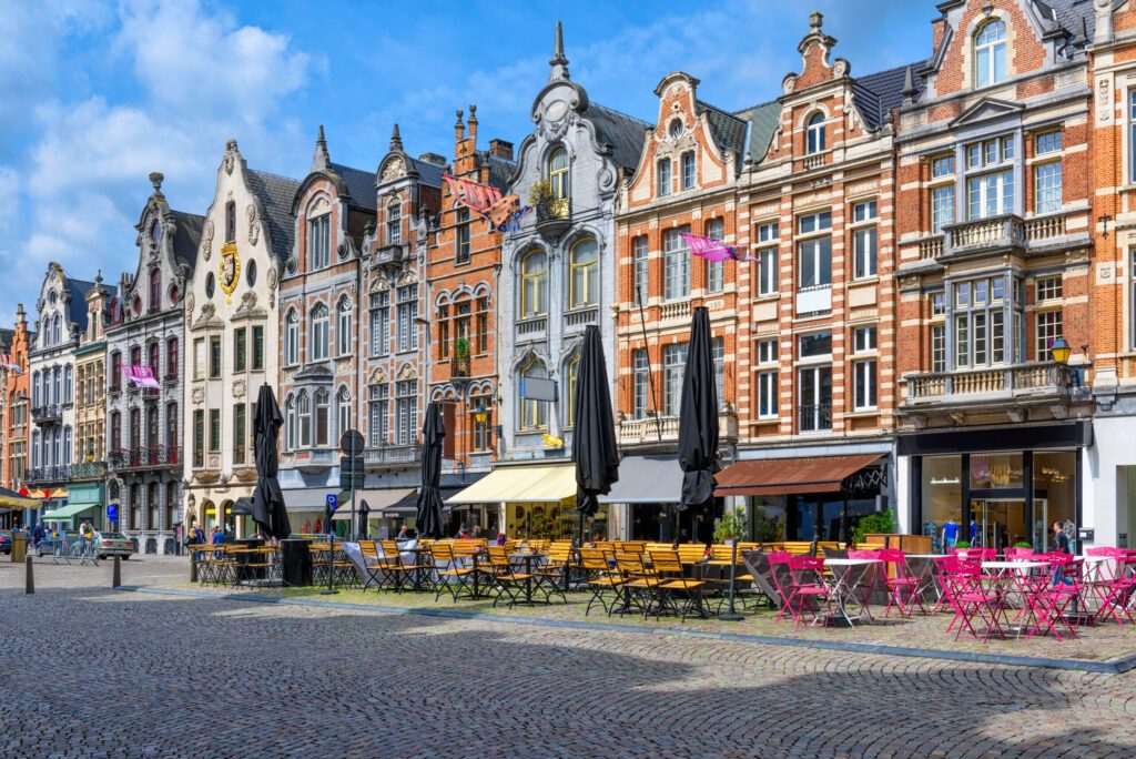 Old street with tables of cafe in Mechelen, Belgium. Mechelen is a city and municipality in the province of Antwerp, Flanders, Belgium.