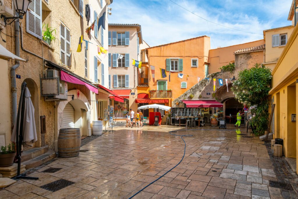 Morning at a small square of shops and cafes in the center of the Old Town section of Saint-Tropez, France, a popular resort on the French Riviera.