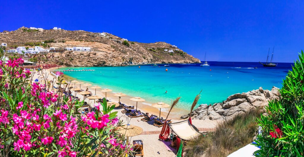 Greece summer vacation. Luxury greek holidays. Stunning Mykonos island. famous Super Paradise beach with  turquoise sea