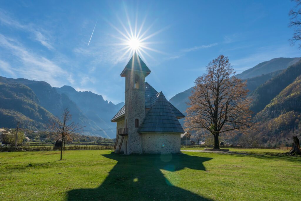 albania theth national park and stone church among mountains blue sky over valley