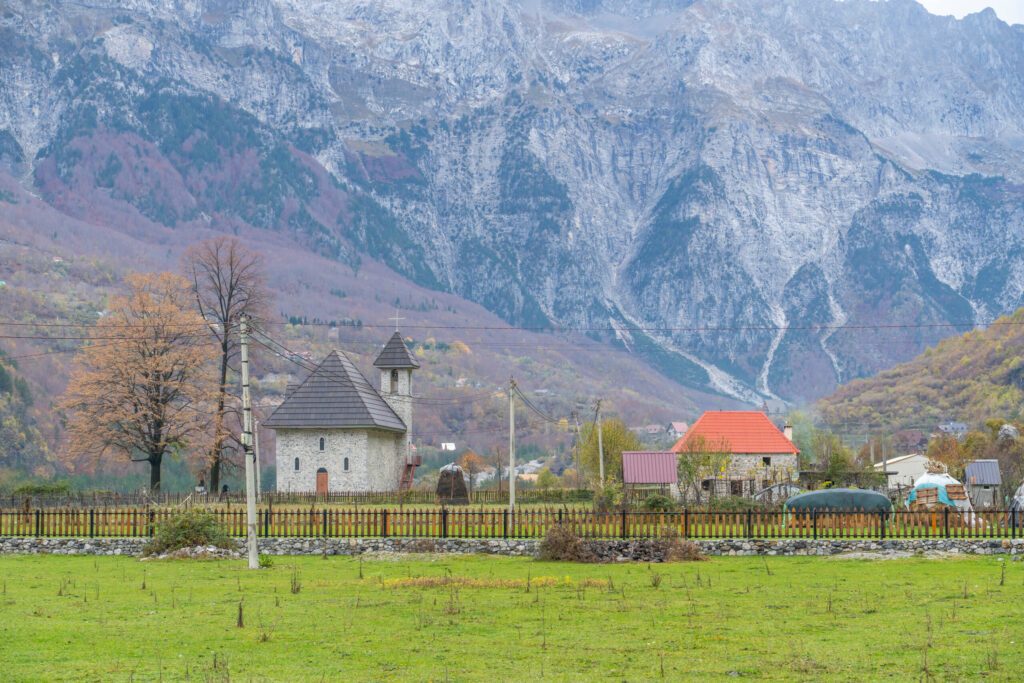 albania theth national park and stone church among mountains blue sky over valley