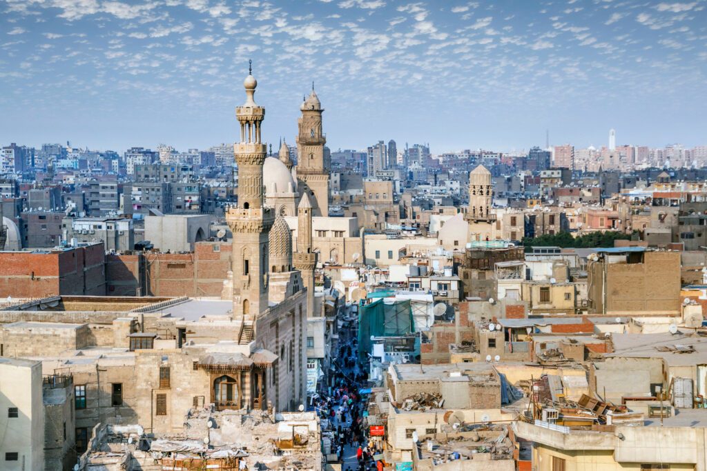 Aerial view of Al-Muizz street of Islamic Cairo with mosques, palaces and residential buildings from the minaret of Sultan Al-Ghuri Mosque-Madrasa, Cairo, Egypt.