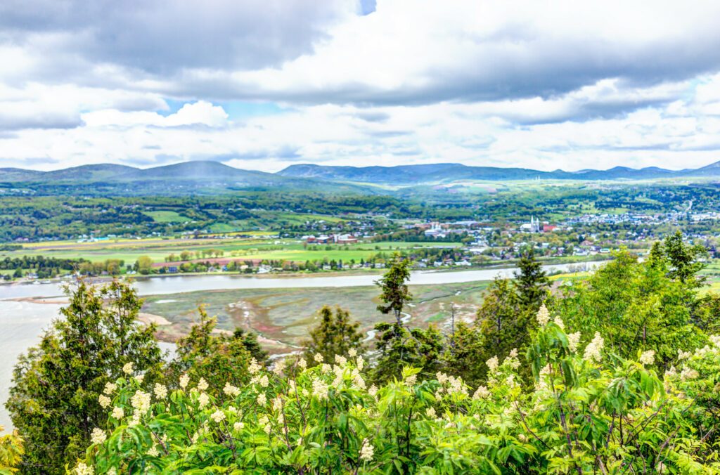 Baie-Saint-Paul in Quebec, Canada cityscape or skyline with buildings, mountains on coast and Saint Lawrence river